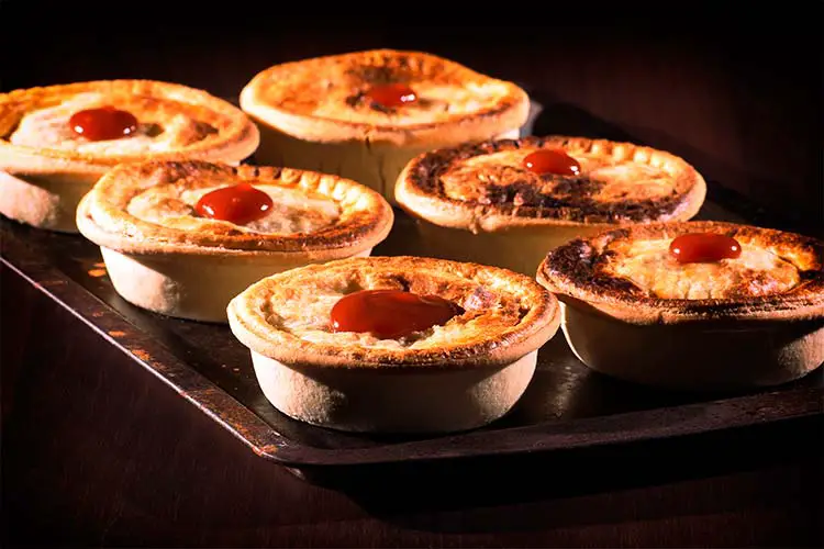 Freshly baked meat pies with sauce