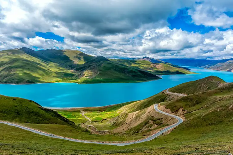 The Yamdrok Lake under the sunny blue sky in Tibet