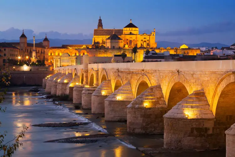 Roman bridge over Guadalquivir river in evening. Cordoba, Spain