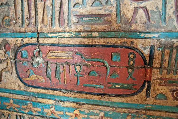 Egyptian hieroglyphic carvings on a wall at the Temple of Khnum in Esna