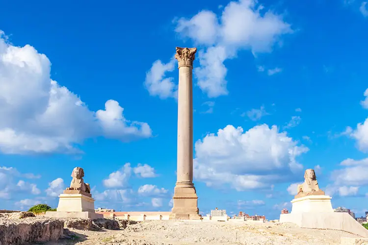 Pompey's pillar and ancient sphinx statue roman triumphal column in Alexandria, Egypt