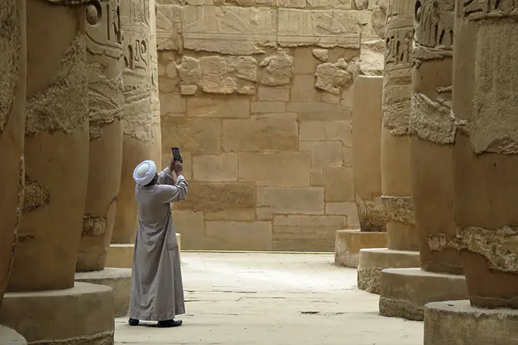 Man taking photos inside Karnak Temple Complex in downtown Luxor